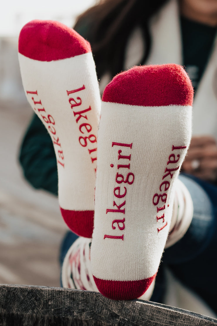 Person wearing 'Lakegirl' socks with a blurred background