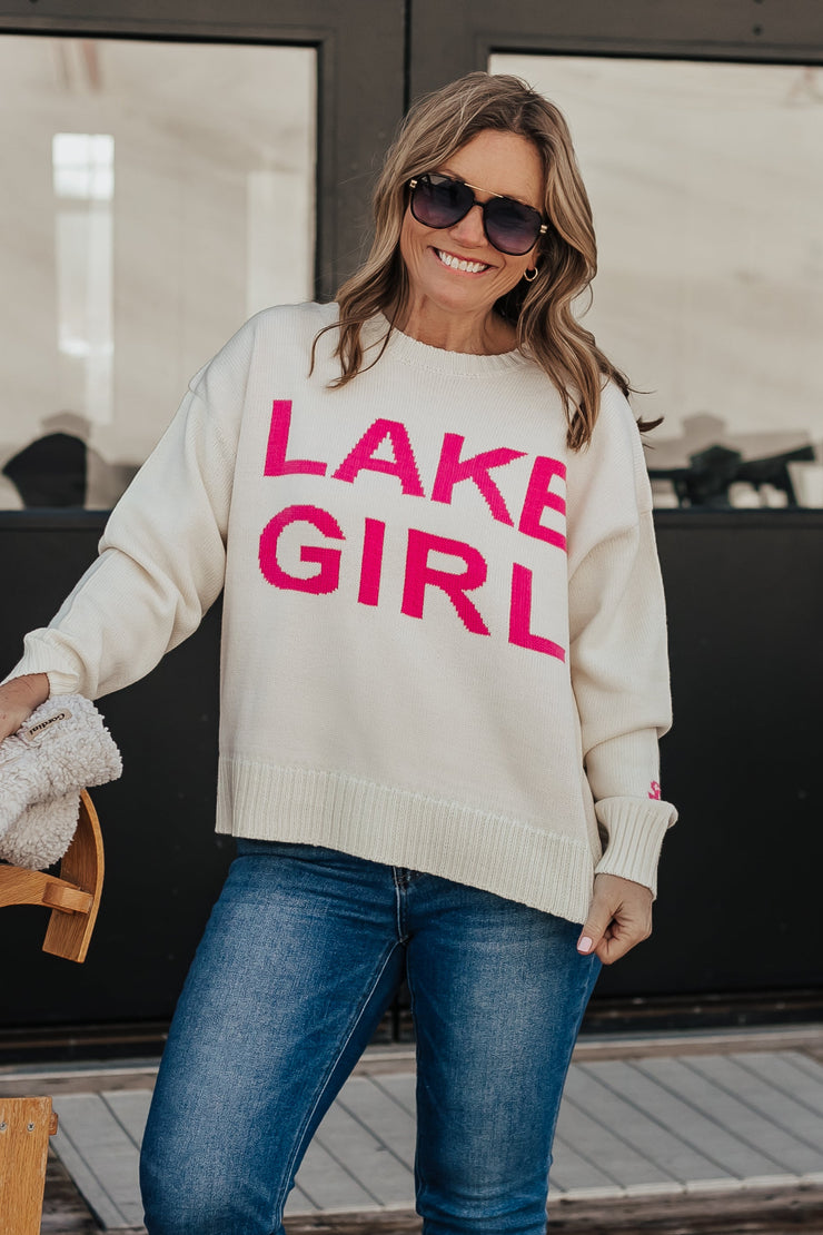 Woman wearing a 'Lake Girl' sweater with sunglasses 