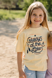 Model wearing youth tee in butter color